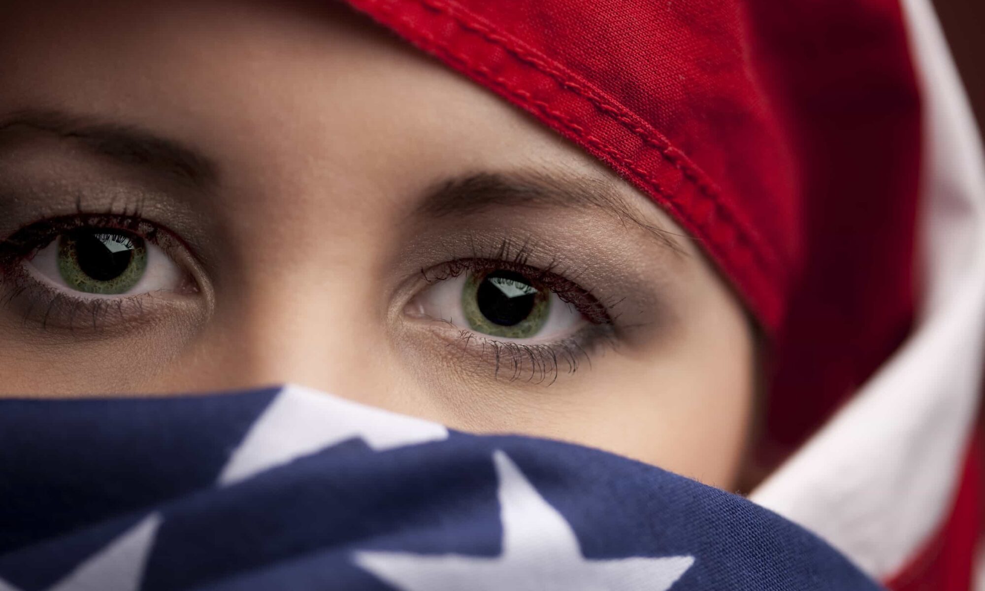 Girl in flag scarf representing Citizenship-status discrimination lawyers Los Angeles.